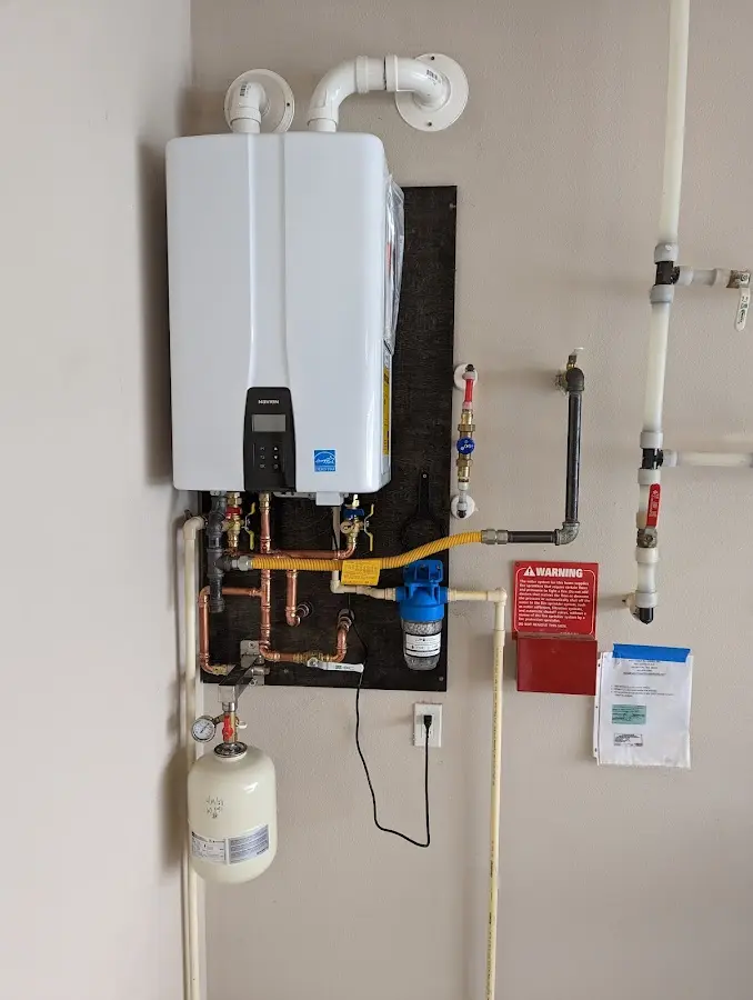 Professional plumber installing copper piping in a Torrington home